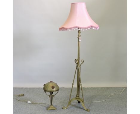 An Art Nouveau brass standard lamp and shade, together with a similar table lamp, with brass shade