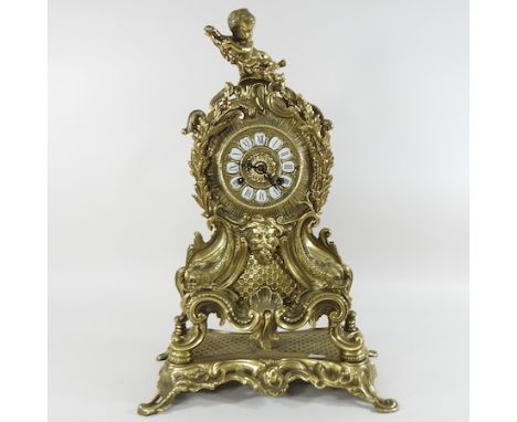 An ornate 19th century French brass cased mantel clock, 52cm high