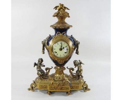 An ornate continental gilt metal mounted porcelain mantel clock, 53cm high