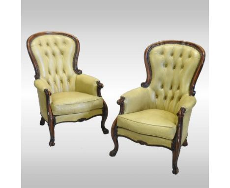 A pair of Victorian style cream leather upholstered carved mahogany show frame armchairs, each with a button back, on cabriol