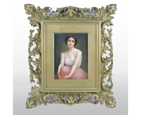 A 19th century German KPM porcelain plaque, depicting a half-length portrait of young lady, wearing a white top and a red ski