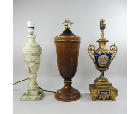 An ornate gilt mounted porcelain table lamp, together with two others, 40cm high