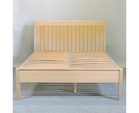 A modern light oak double bedstead, with a slatted base, 154cm wide