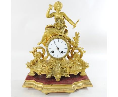 A 19th century French gilt spelter mantel clock, together with an alabaster table lamp, 33cm high