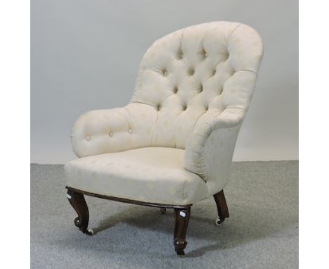 A Victorian cream upholstered button back armchair