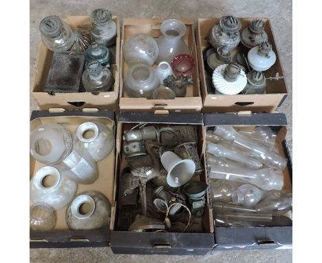 A collection of oil lamps, shades and funnels, together with a collection of vintage lamps and light fittings