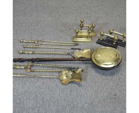 A collection of brass fire tools, to include two pairs of fire dogs 