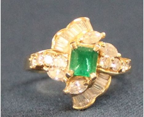 Diamond &amp; emerald stylised ring marked 750 set with octagonal step cut emerald&nbsp; 0.75ct and 8 brilliant cut diamonds,