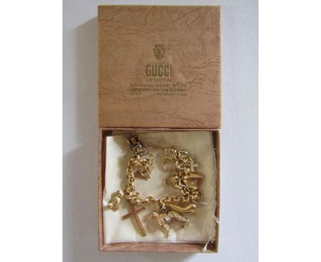 9ct gold charm bracelet with 18k gold cross and bird charm, 14ct gold heart with diamond charm and 9ct gold dog and bear char