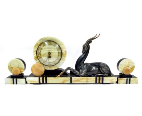 Art Deco green marble and black slate garniture clock, the 7" circular dial flanked by a recumbent gazelle, 24" wide (3)