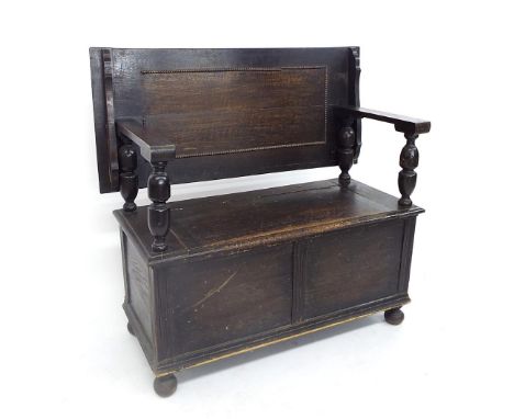 Good oak monk's bench, the arms upon cup and cuff supports over a hinged box, 40" high x 40" wide and 18" deep