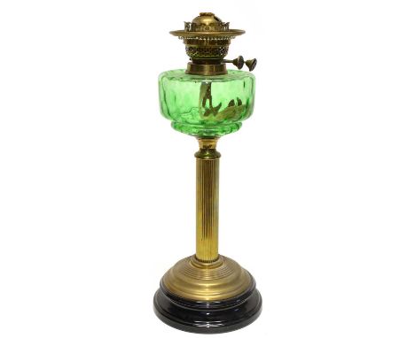Victorian oil lamp, green glass reservoir on brass column with black ceramic base.height 48cm (19")