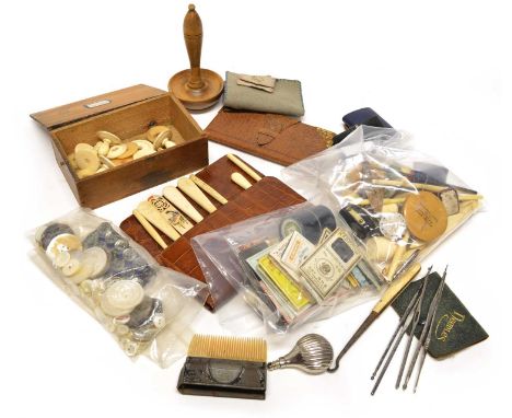 A collection of hardwood, ivory and bone late 19th-century sewing accessories including tape measures, mother-of-pearl button