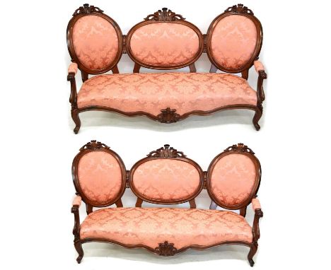 Mid 19th century continental Louis XV design matching pair of sofas, each with carved and moulded frame, triple oval back, pa