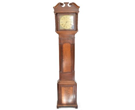 Joyce Ruthin 30 hour longcase clock with eleven-inch brass dial, chapter ring with Arabic and Roman numerals, oak and mahogan