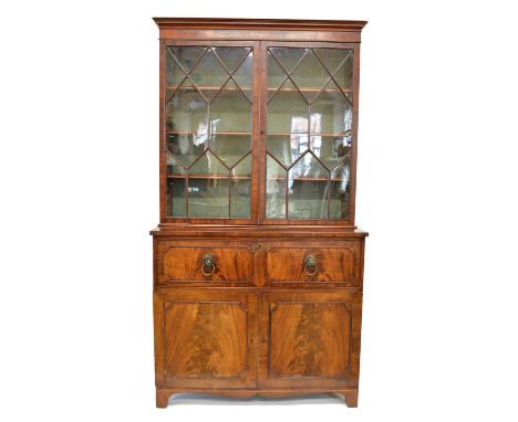 George III mahogany glazed bookcase on cupboard, top section with moulded cavetto white wood string and cross-banding, double