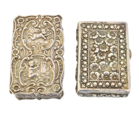 Two Elizabeth II silver pill boxes, one embossed with putti, the other with floral decoration, Da-mar Silverware, London, 197