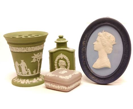 Four pieces of Wedgwood jasperware to include a green flower vase, green tea caddy canister, lilac square trinket box and an 