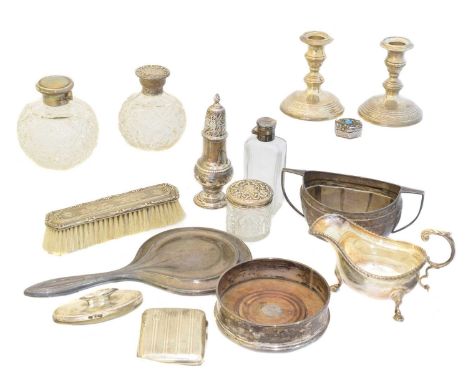 A large selection of silver items, to include a pair of candlesticks, dressing table items, wine coaster, sauce boat, etc. gr