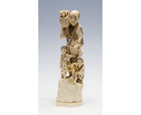 A Japanese ivory tusk carving okimono of a farmer carrying a basket with two infants, Meiji period, 1868-1912, signed, height