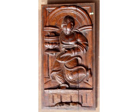 Oak late 16th Century thickly carved oak panel with folk art depiction of 'St Clare' carrying a monstrance, within an archite