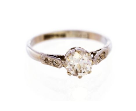 A diamond solitaire 18ct white gold ring, with diamond set shoulders, the round old-cut weighing approx 0.75 carat, assessed 