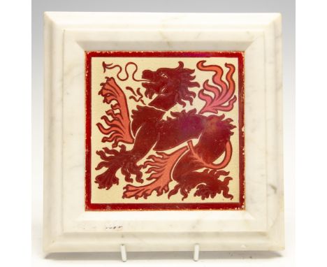 An Arts and Crafts Tile in manner of William De Morgan, of a red lustre styalised dragon on a cream background set within a w