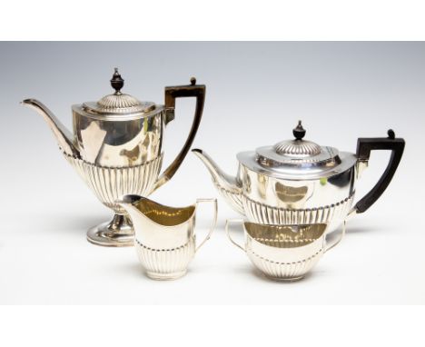 A late Victorian matched silver four piece tea and coffee service in the Georgina manner with gardroon fluted bodies, ebonise