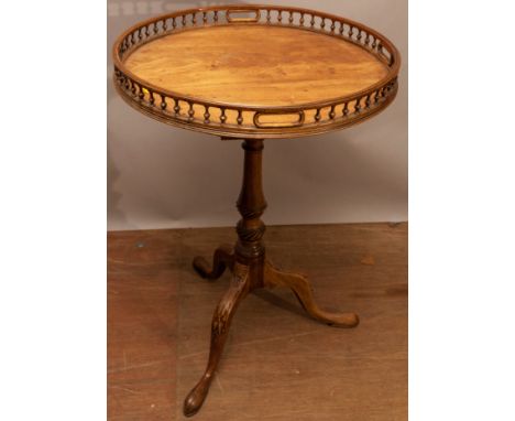 A George III mahogany tripod table, with tilt-top bird cage mechanism, spindle gallery