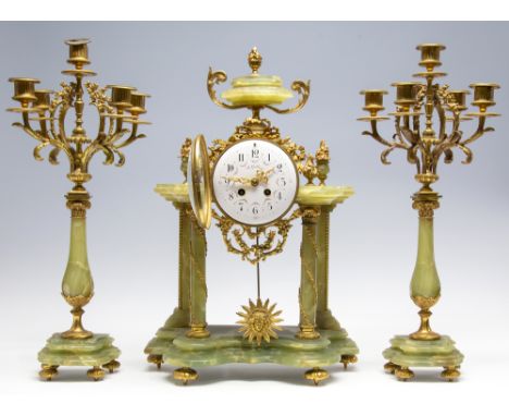 A late 19th Century French gilt metal and green onyx clock garniture, the enamel dial signed A. Gallier, sun king pendulum, c