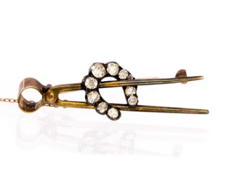 An Edwardian diamond-set horseshoe and farrier pliers yellow gold brooch, ten off round old-cut diamonds, total diamond weigh