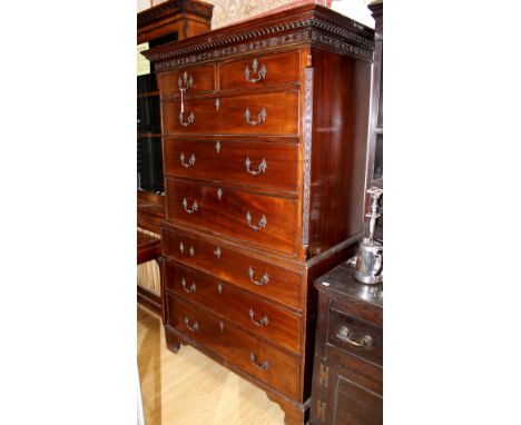 A George III mahogany chest on chest, the cornice with dentil moulding and blind fretwork, the upper section with two short o