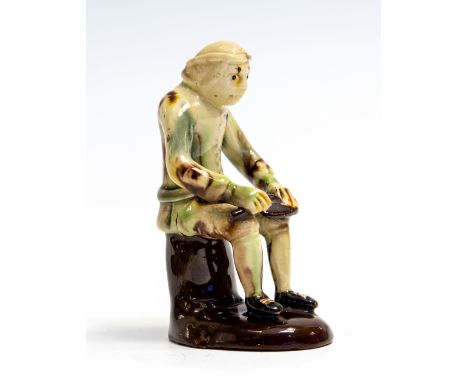 A mid 18th Century English Whieldon type pottery model of a seated cobbler, circa 1750, height 11.5cmProvenance: Jonathan Hor