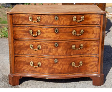 A George III mahogany serpentine fronted chest of drawers, circa 1765, fitted with four long graduated drawers, the top drawe