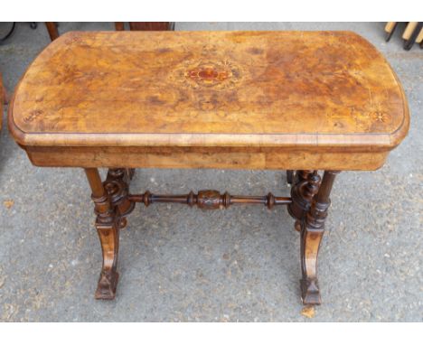 A mid Victorian walnut and marquetry inlaid fold-over card table, circa 1870, the top swivelling round and opening to reveal 