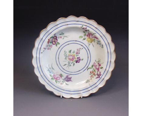 A Worcester plate, scalloped rim, painted with a gilt rim and blue lines and five flower sprays  by James Giles, circa 1770, 