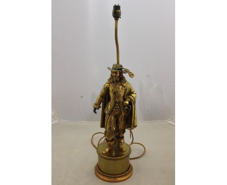 An early 20th Century gilt metal electric table lamp, in the form of a cavalier, on a raised circular socle, height 60cm