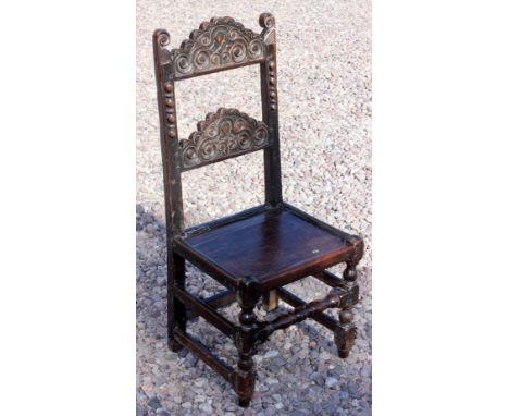 Yorkshire/ Delbourne carved oak ladder back joined chair, late 17th Century with unusually flat edge to the bottom of the lad
