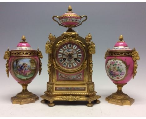 A 19th Century French ormolu bracket clock garniture, circa 1870, of Baroque design, pink and jewelled Sevres style porcelain
