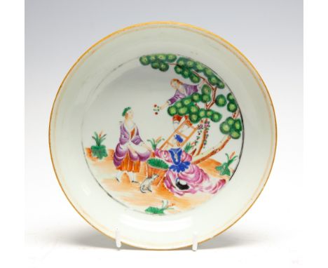 A Chinese 'European Subject' cherry-pickers saucer dish, Qianlong period (1735-1795), a man on a ladder drops fruit to two la