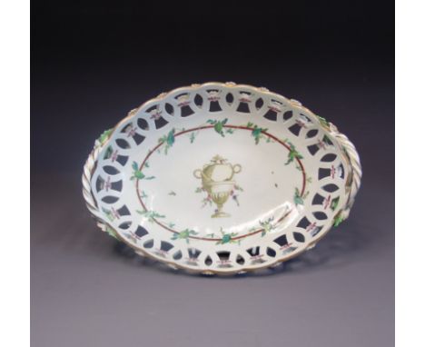 A Worcester pierced oval basket, painted with a classical urn and a green leaf garland by James Giles, gilt and white rope tw