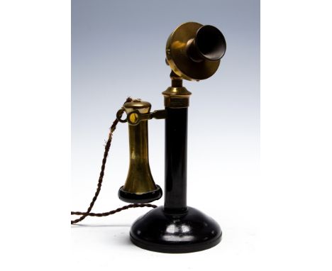 A circa 1920's candlestick telephone, black metal with brass fittings and vulcanite mouthpiece, maker Peel-Conner Telephone W