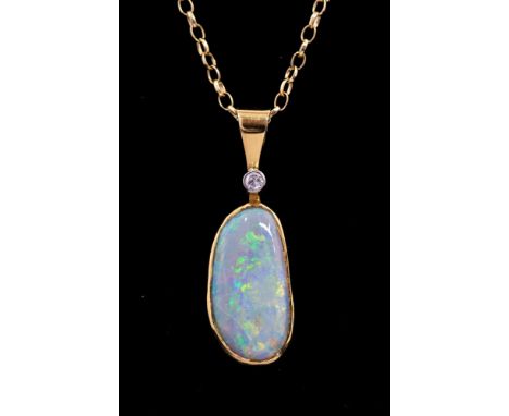 An 18ct yellow gold opal and diamond pendant, set with an asymetric opal approx 19mm x 9mm, with green and orange play of col