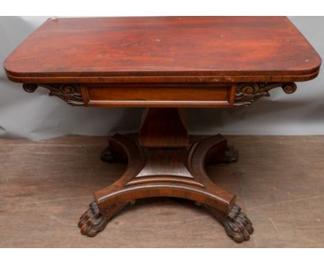 An early 19th Century rosewood fold-over card table, circa 1830, the frieze with scroll carved decoration, the top raised on 