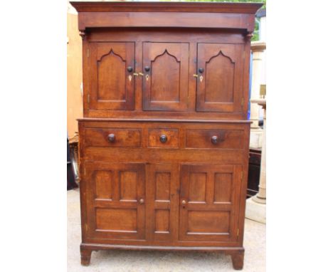 A George III joined oak Deuddarn, circa 1800, attributable to Wales, the upper section with three panelled doors with Gothic 