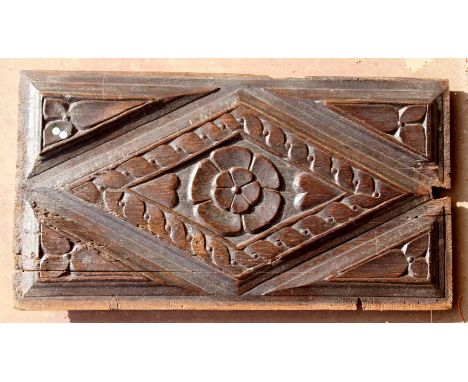 A very thick section carved oak early 17th Century rectangular panel, lozenge bordered by 'chain links', central flower, 8 he