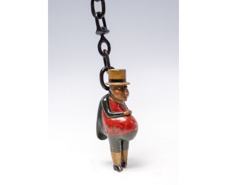 A 19th Century novelty treen snuff box, in the form of a comical large bellied man wearing a top hat, green tunic and red wai