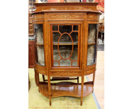 An Edwardian mahogany and marquetry inlaid display cabinet, the top with an inlaid back, inlaid frieze, central glazed door a