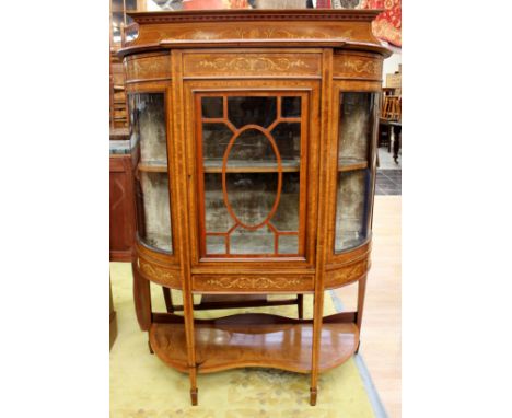 An Edwardian mahogany and marquetry inlaid display cabinet, the top with an inlaid back, inlaid frieze, central glazed door a