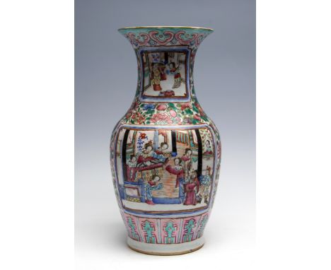 A mid 19th Century Cantonese enamel baluster vase, decorated in the famille rose pallette with panels of figure scenes on a f